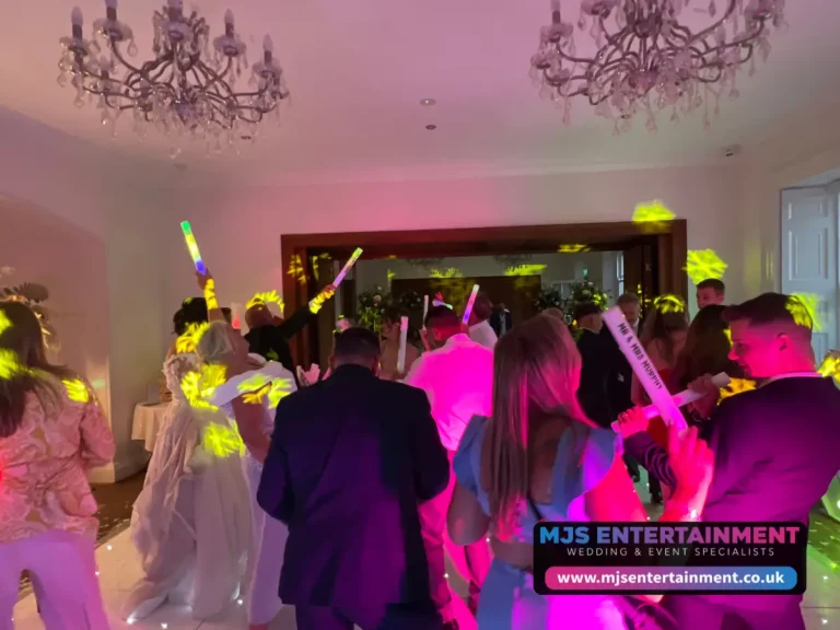 Guest using our light up dance floor sticks hire for a wedding - Disco hire uk